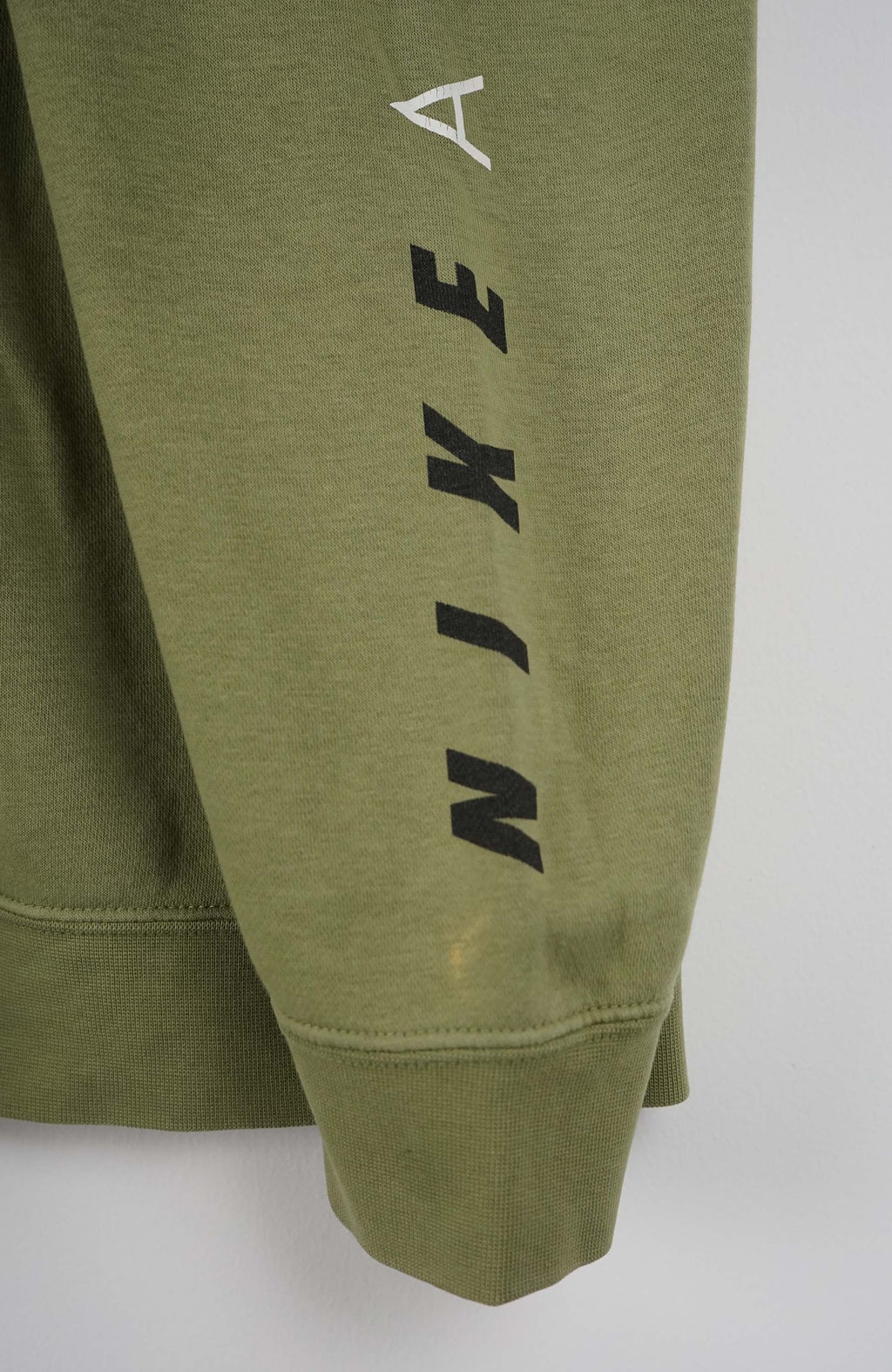 Green Nike sweatshirt with logo on a white background