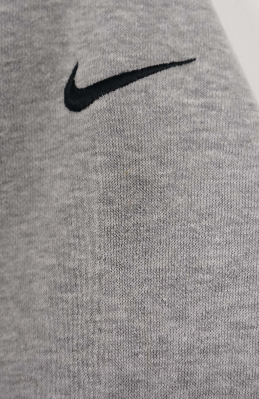 Gray sweatshirt with Nike logo on a white background