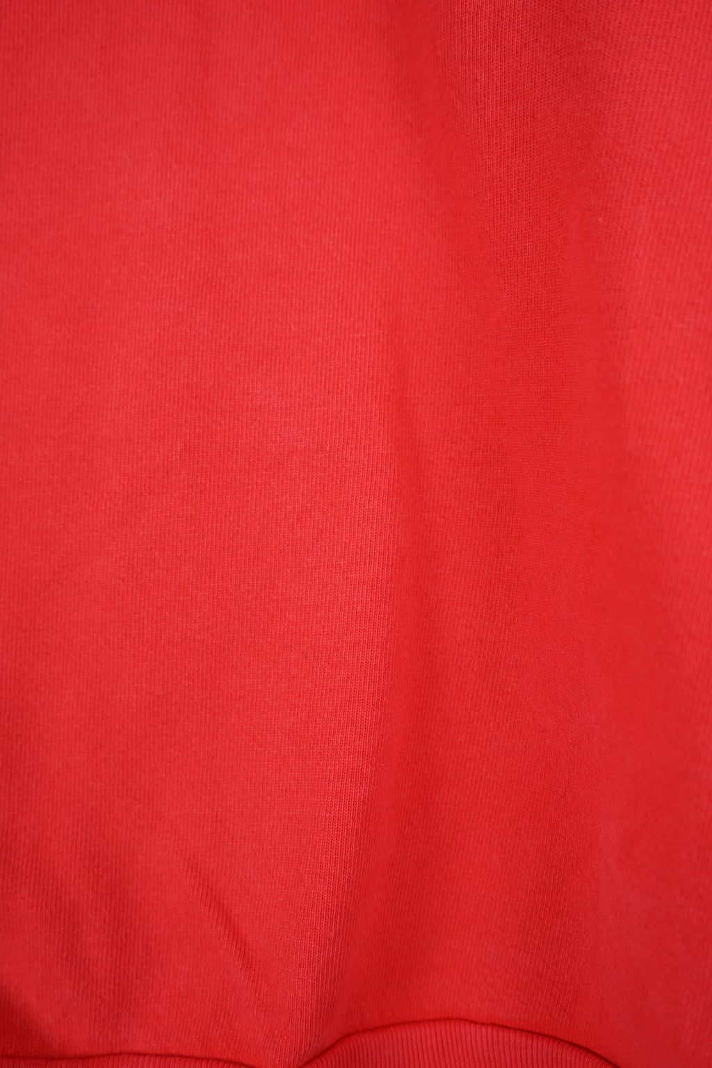 Red sweatshirt with 'Guess' logo on a white background