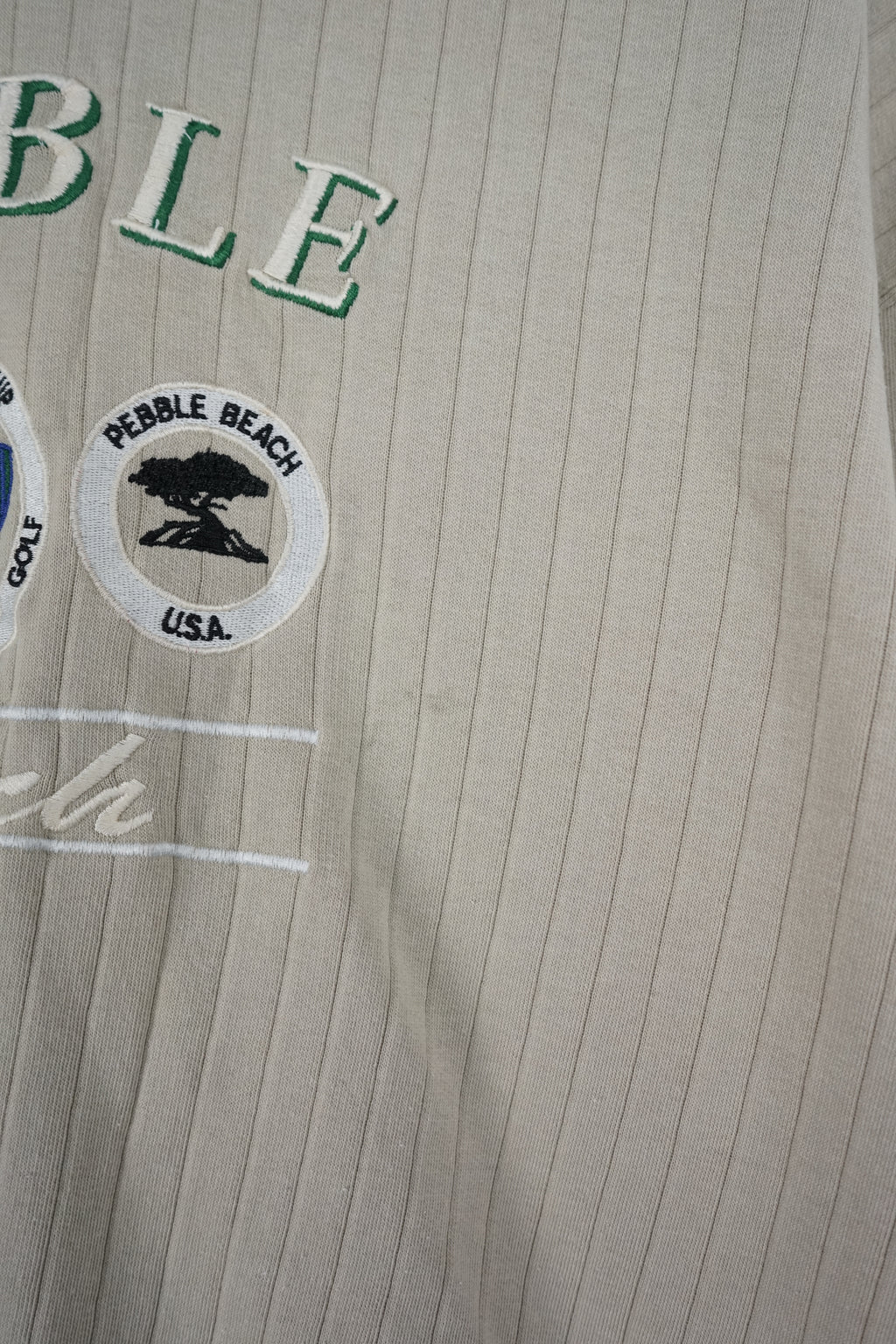 Beige ribbed sweater with 'Pebble' branding on a white background