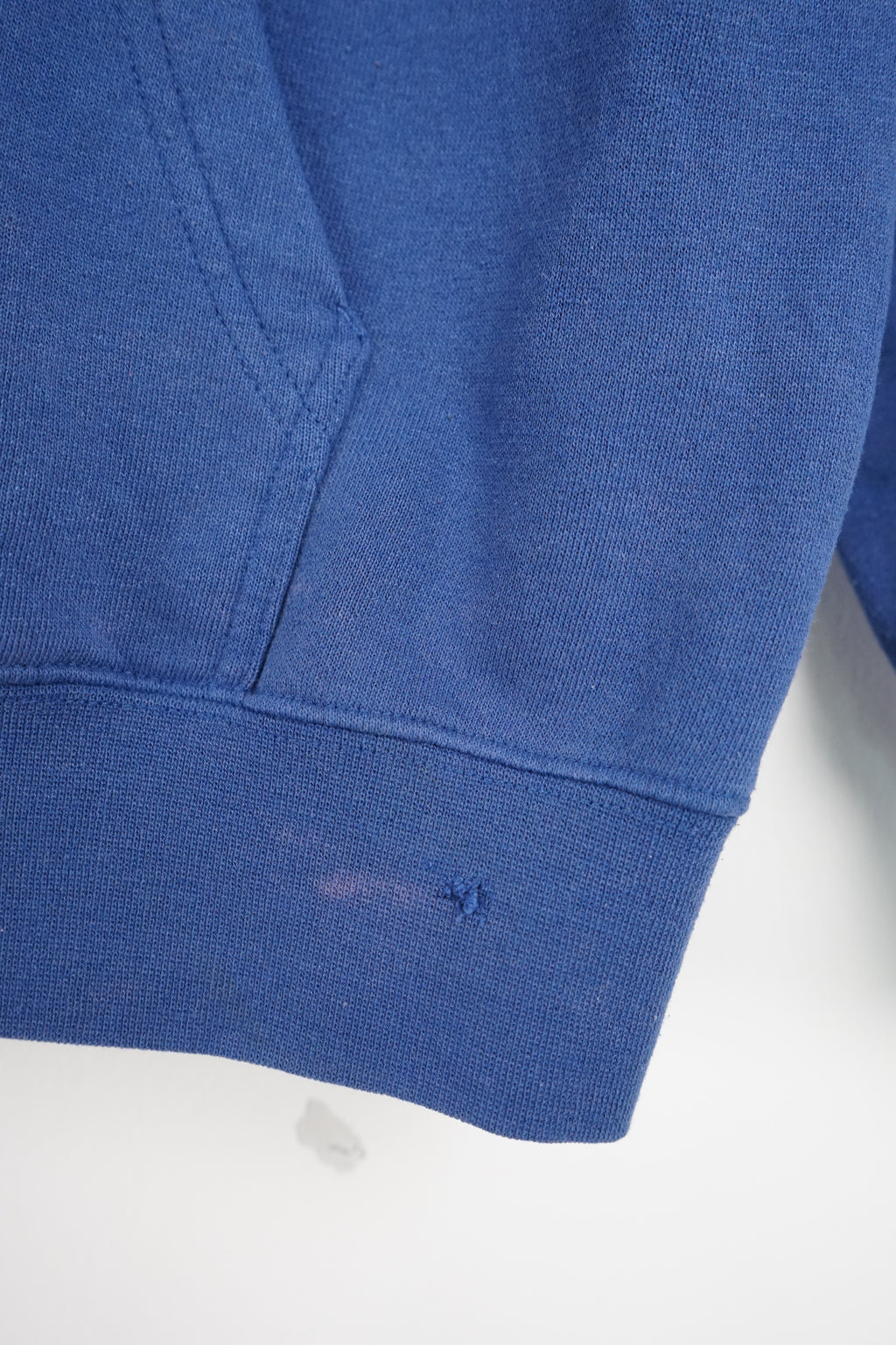 Blue Adidas hoodie with white stripes on a white background