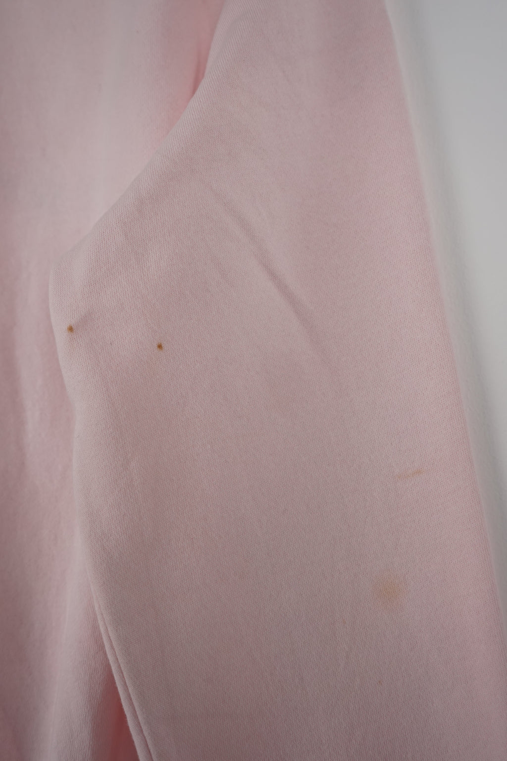 Pink Tommy Hilfiger sweatshirt on a white hanger