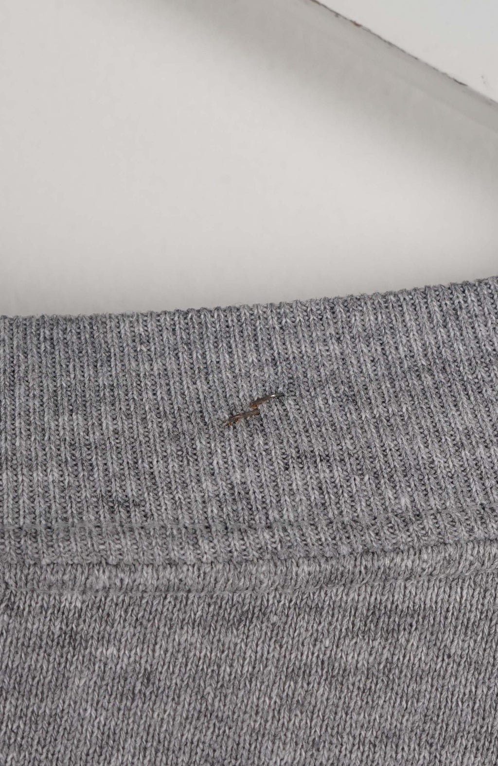 Gray sweatshirt with a small logo on a white background