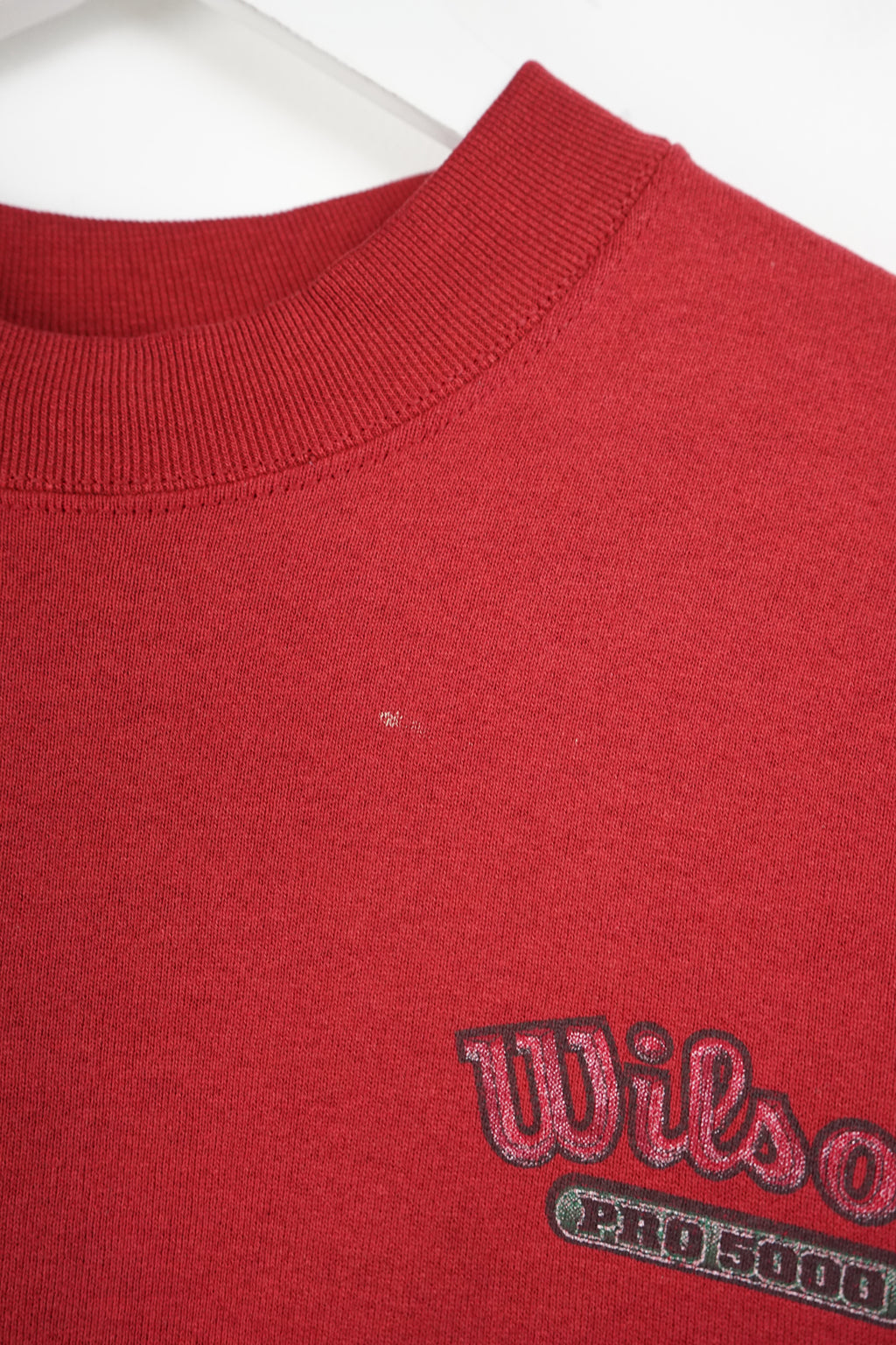 Red sweatshirt with a logo on a white background