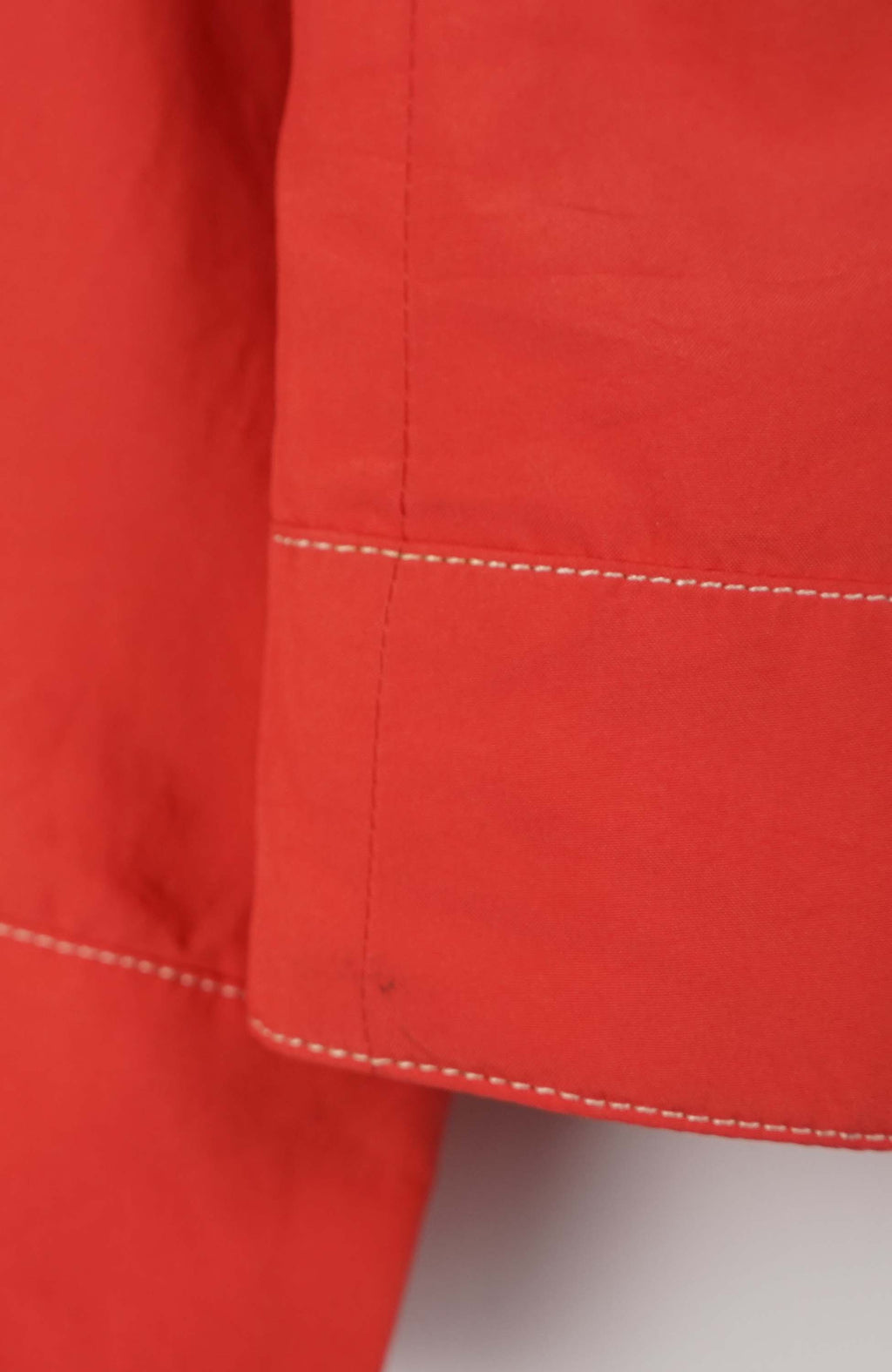 Red and white striped shirt on a hanger against a white background
