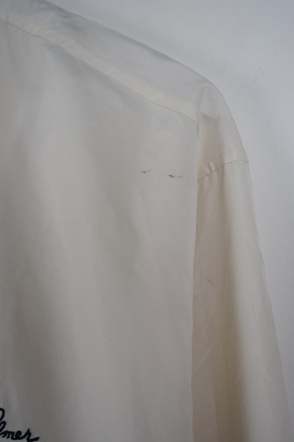 White jacket with black accents on a white background