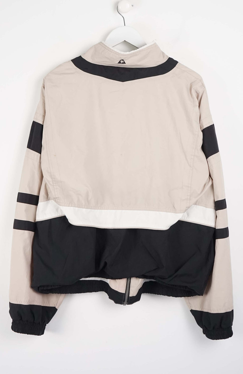 Beige and black jacket with striped pattern on a white background