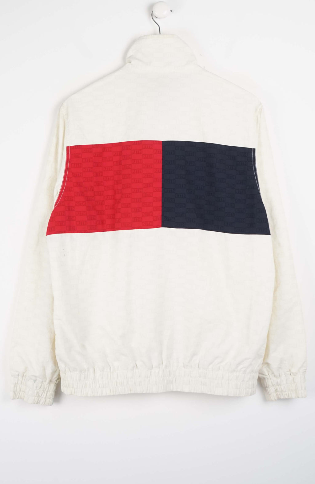 White jacket with a navy pocket on a white background