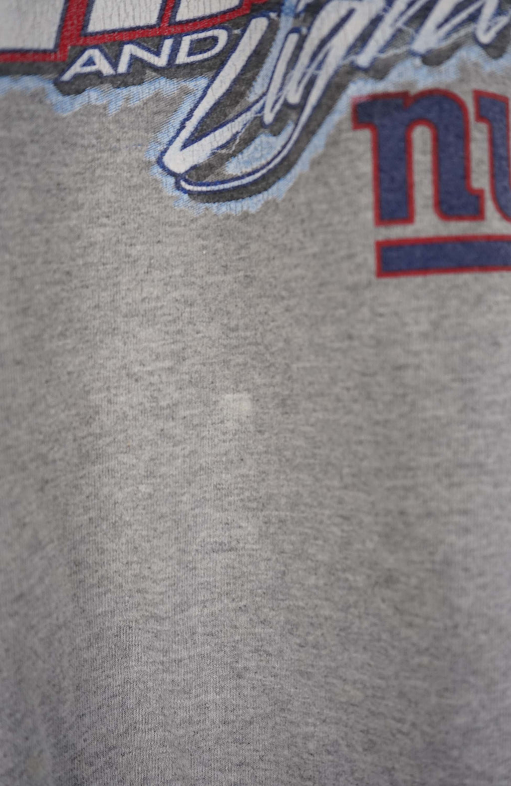 Gray t-shirt with sports-themed graphic on a white background