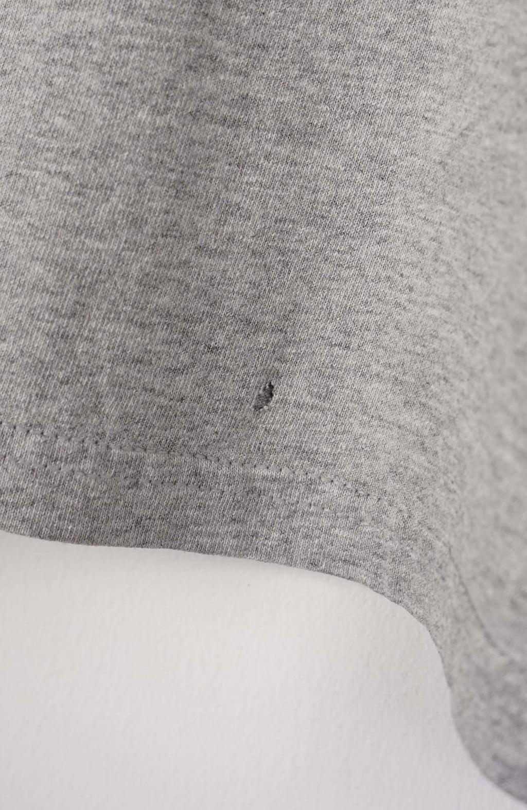 Gray long-sleeve shirt with Tennessee Titans logo on a white background