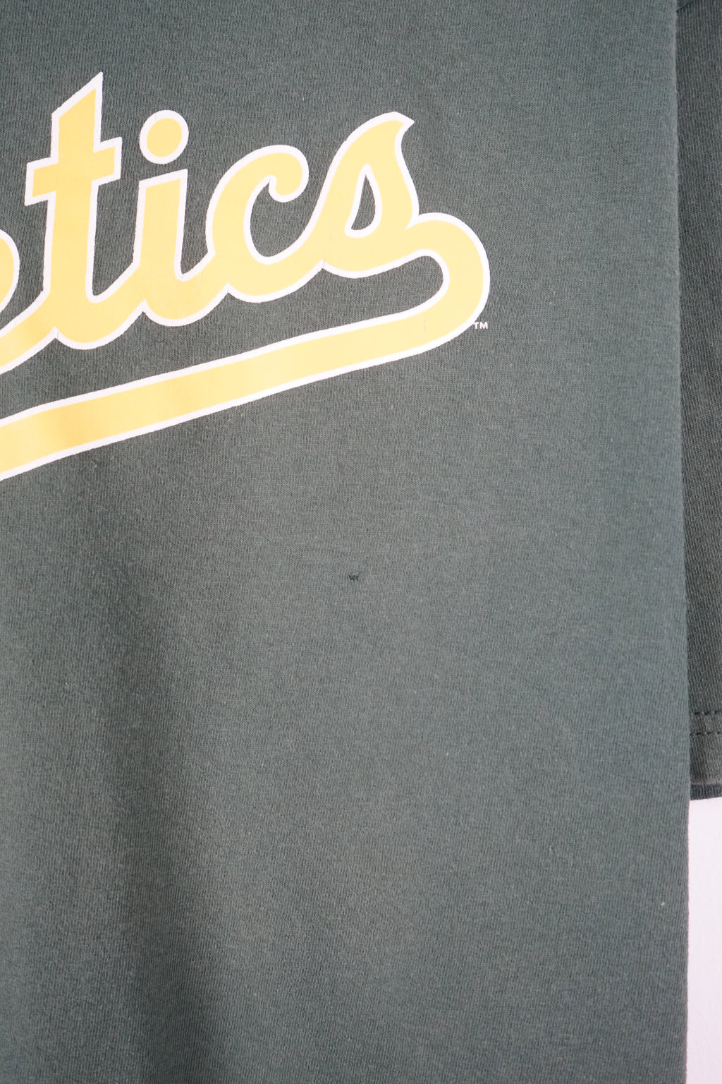 Green t-shirt with 'Athletics' text on a white background