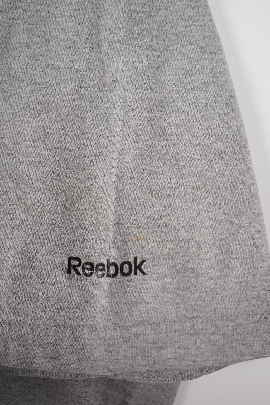 Gray t-shirt with Steelers logo on a white hanger