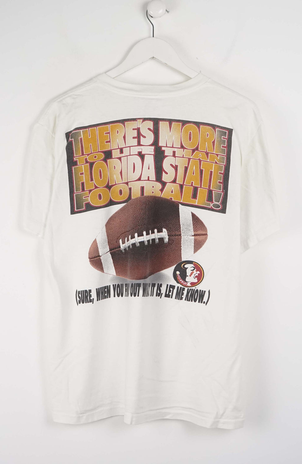 White t-shirt with a football helmet and 'Seminoles' text on a hanger against a white background
