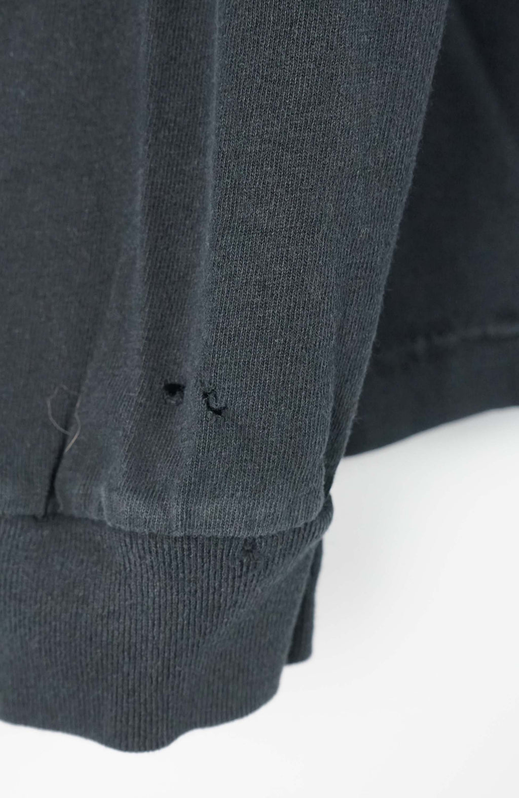 Black long-sleeve shirt with 'Steelers' and Reebok logos on a white background