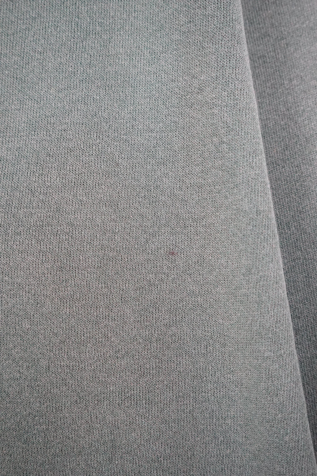 Green sweatshirt with a small logo on a white background