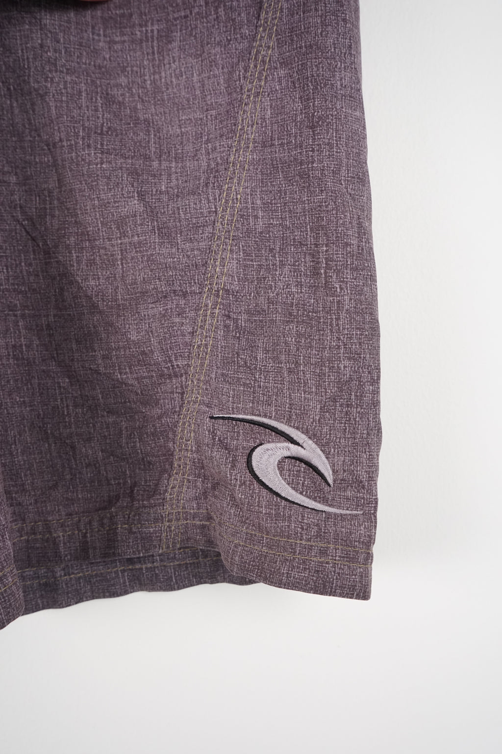 Gray shorts with a black drawstring on a white background