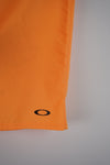 Close-up of an orange fabric with a black circle on a light gray background