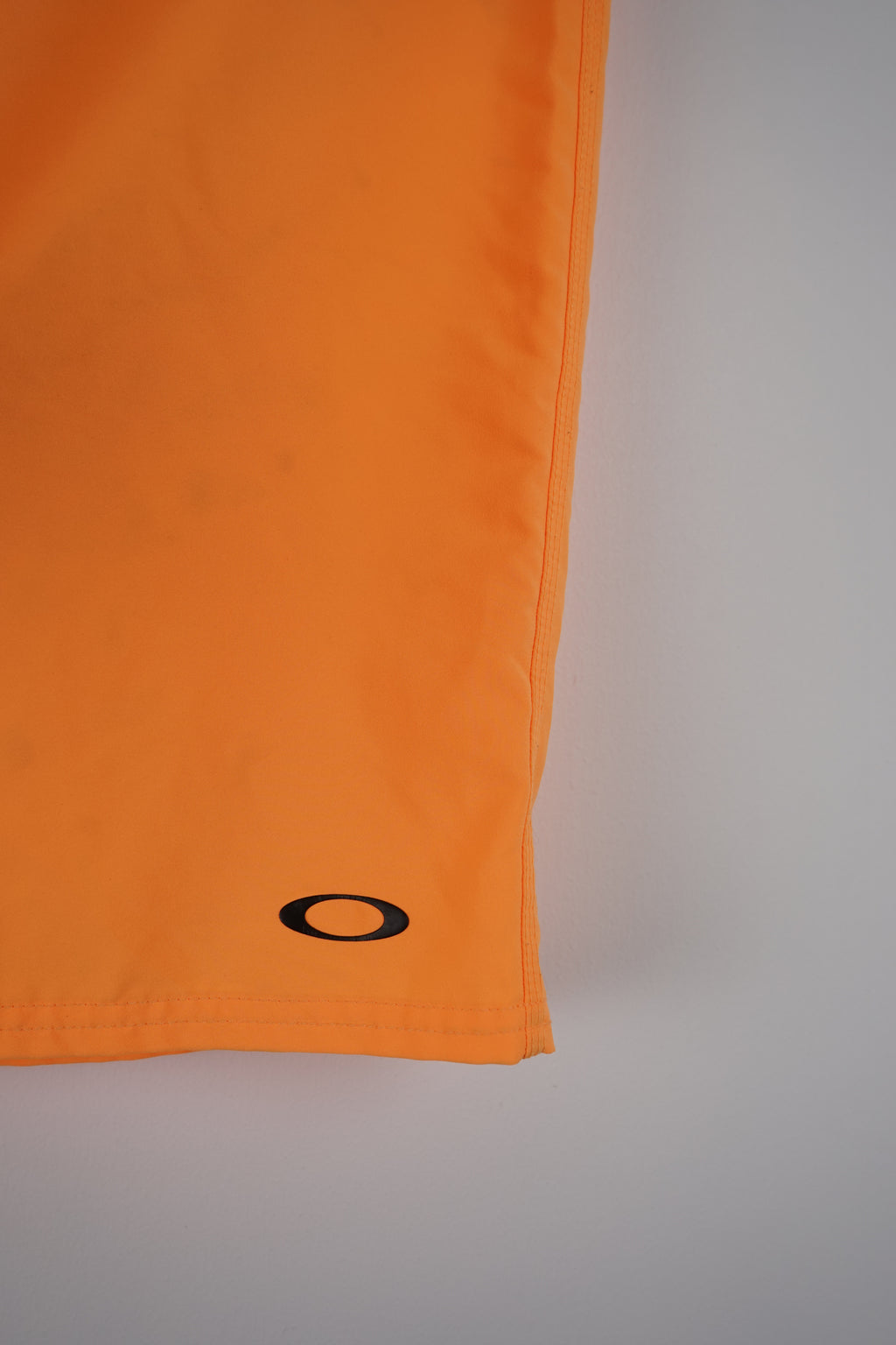 Orange shorts with a brand logo on a white background