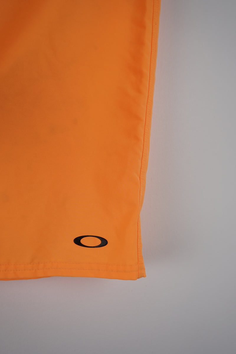 Close-up of an orange fabric with a black circle on a light gray background