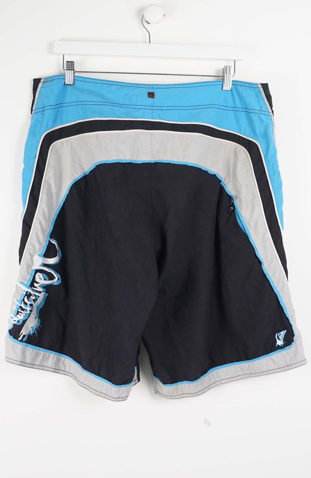 Black shorts with blue side panels on a white background