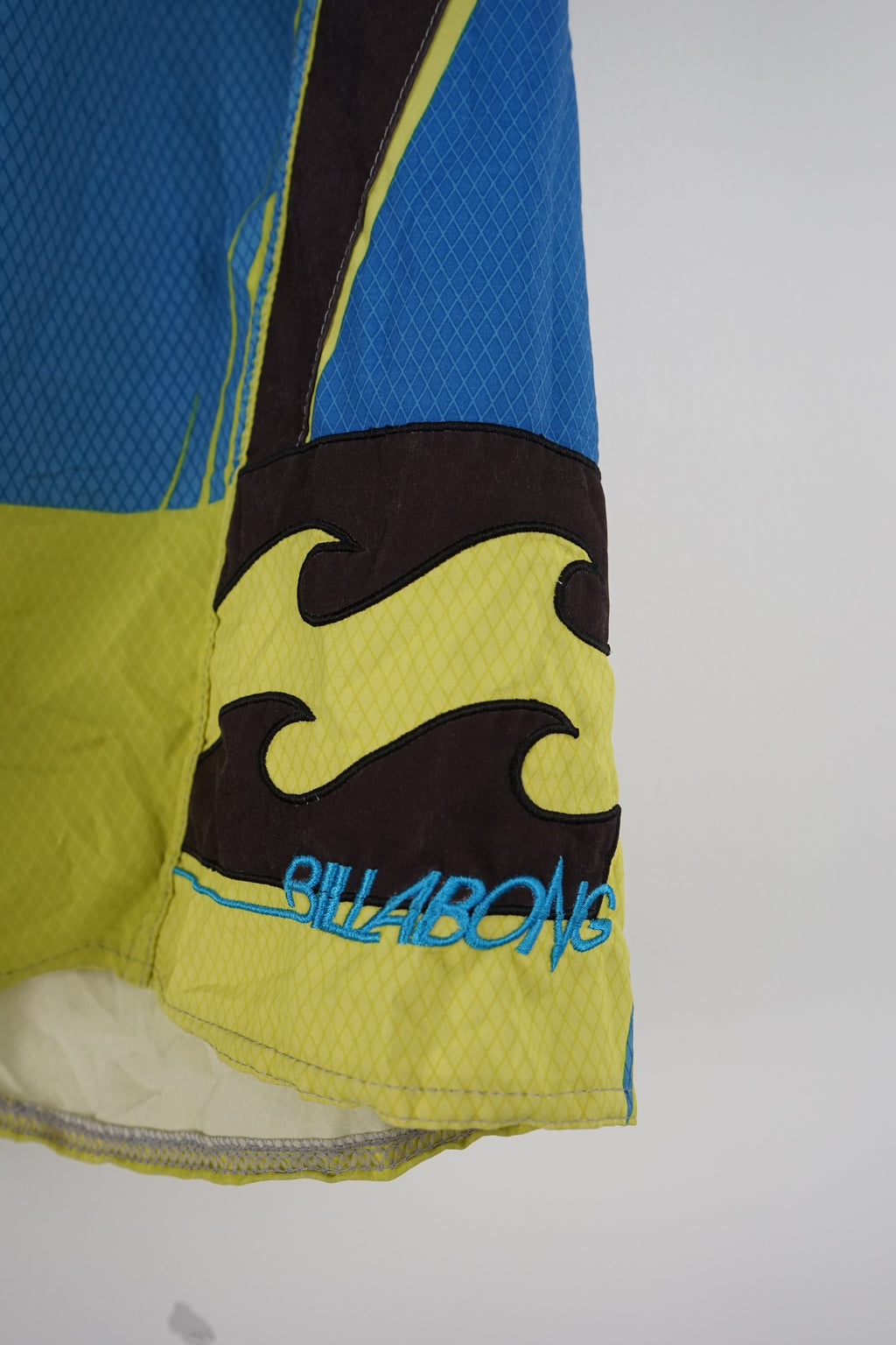 Multicolored shorts with a brand logo on a white background
