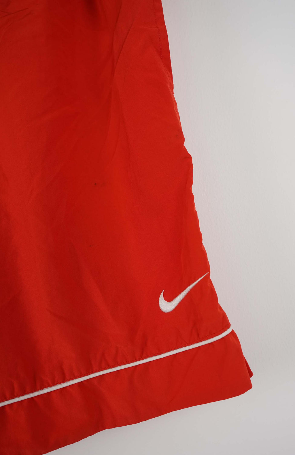 Red shorts with a Nike logo on a white background