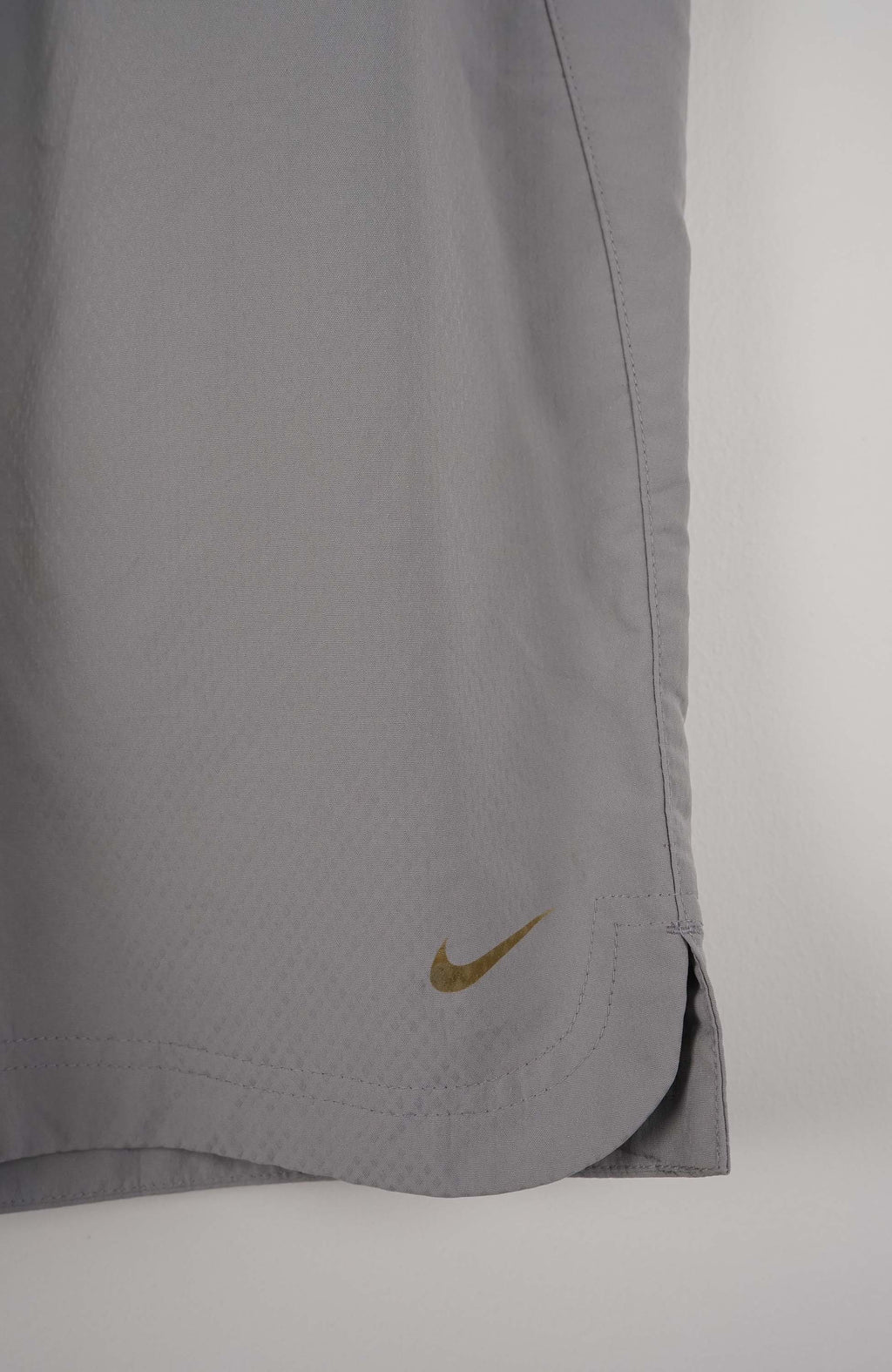 Gray shorts with a Nike logo on a white background