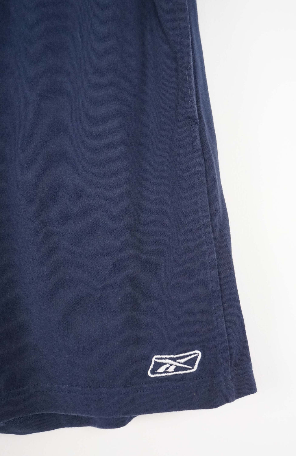 Navy blue shorts with a brand logo on a white background
