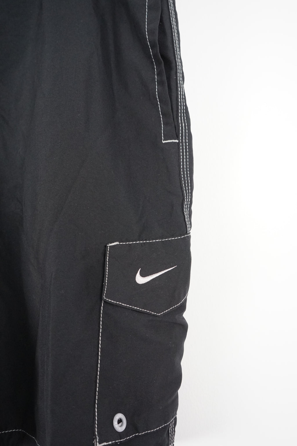 Black shorts with a Nike logo on a white background