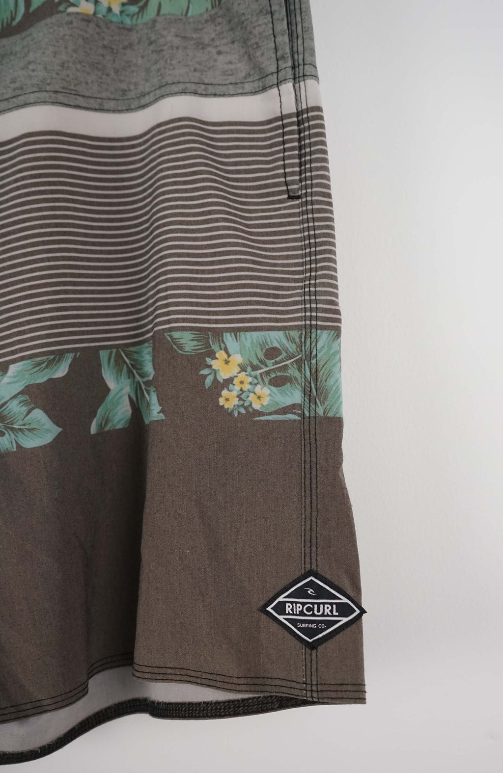 Brown shorts with floral patterns on a white background