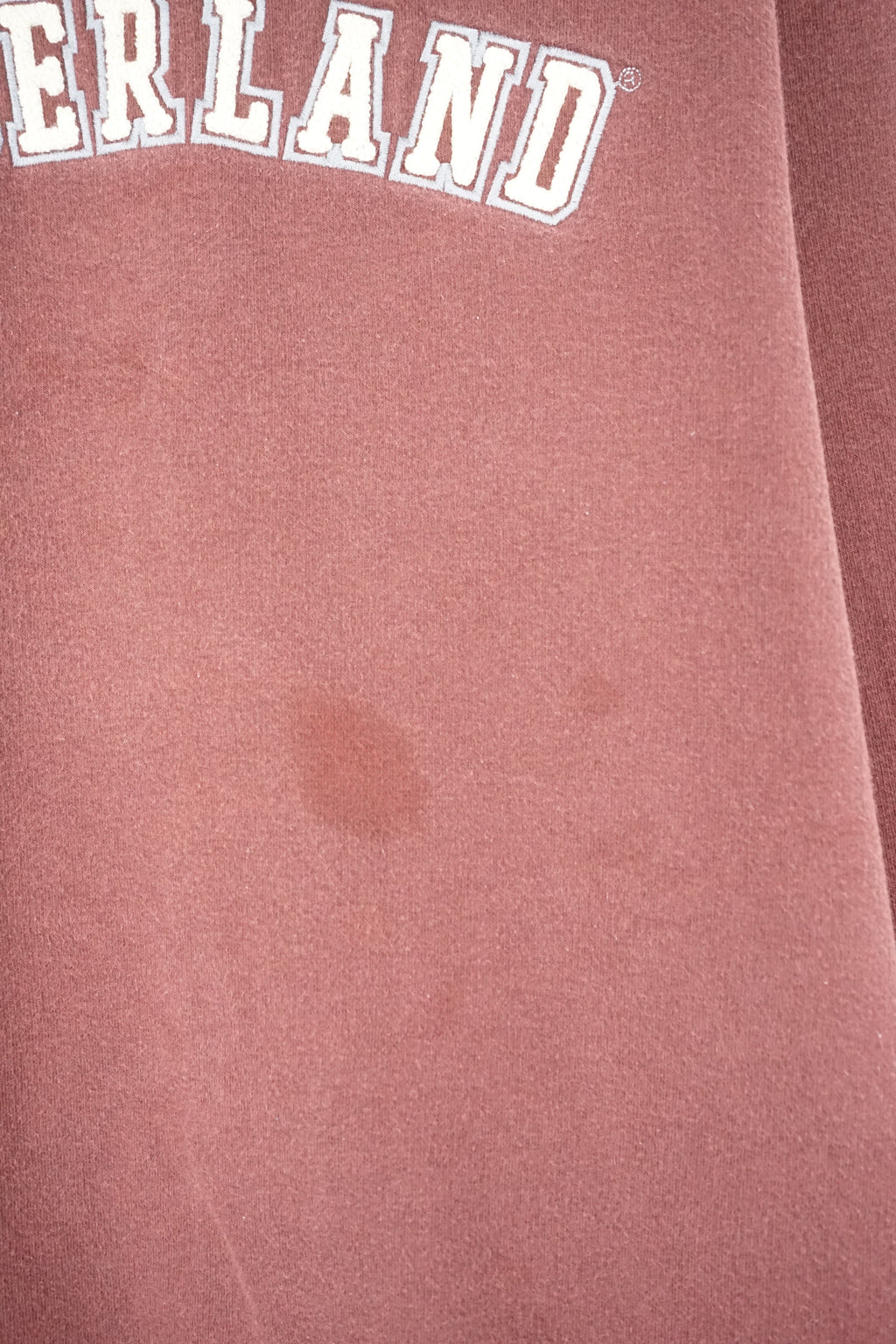Maroon sweatshirt with 'TIMBERLAND' logo on a white background