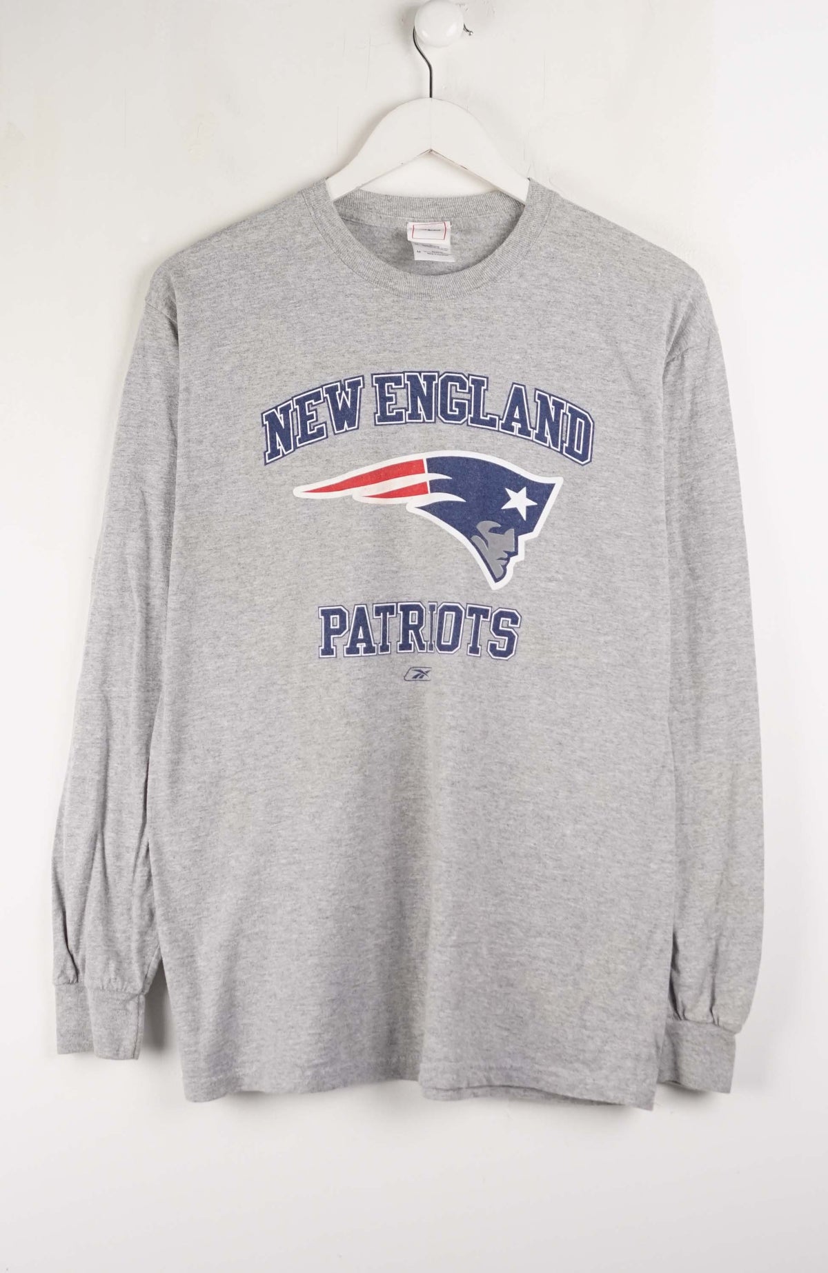 Gray long-sleeve shirt with New England Patriots logo on a white background