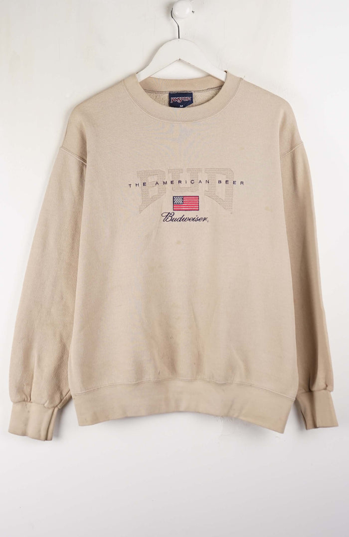 Beige sweatshirt with text and logo on a white background