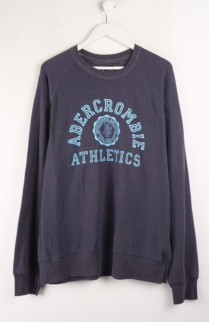 Navy blue Abercrombie sweatshirt on a white hanger against a white background
