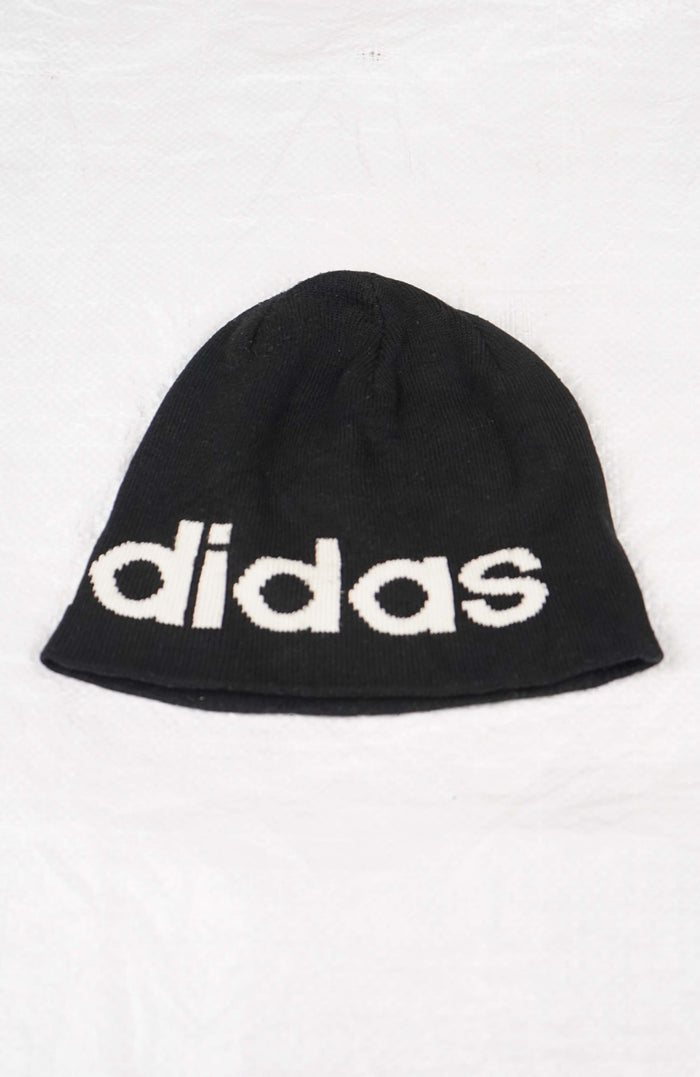 Black beanie with Adidas logo on a white background
