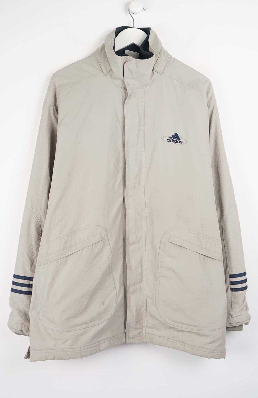 Beige jacket with Adidas logo on a white background
