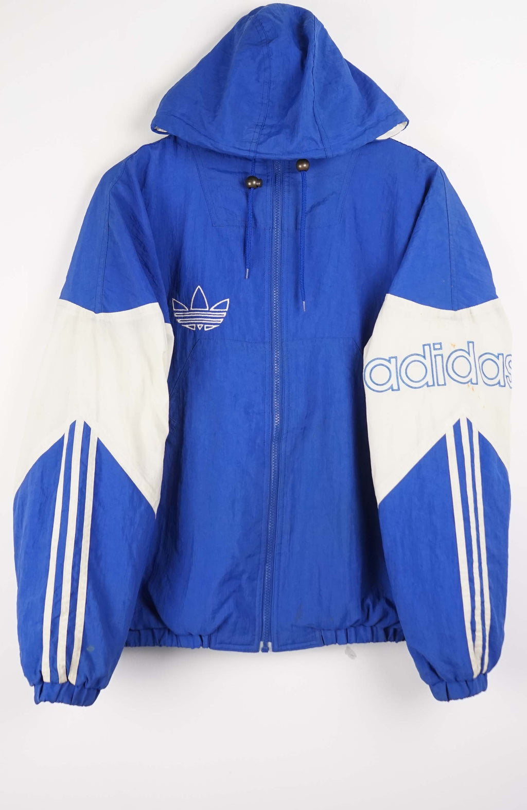 Blue and white Adidas jacket with brand logos on a white background