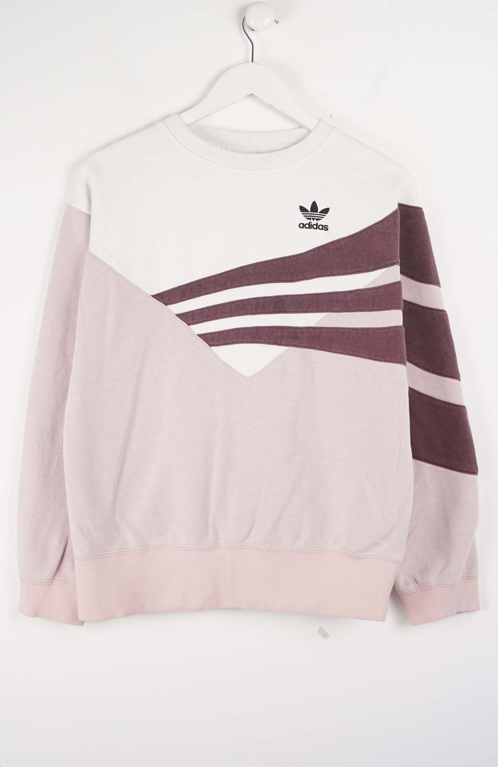Pink Adidas sweatshirt with white stripes on a white background