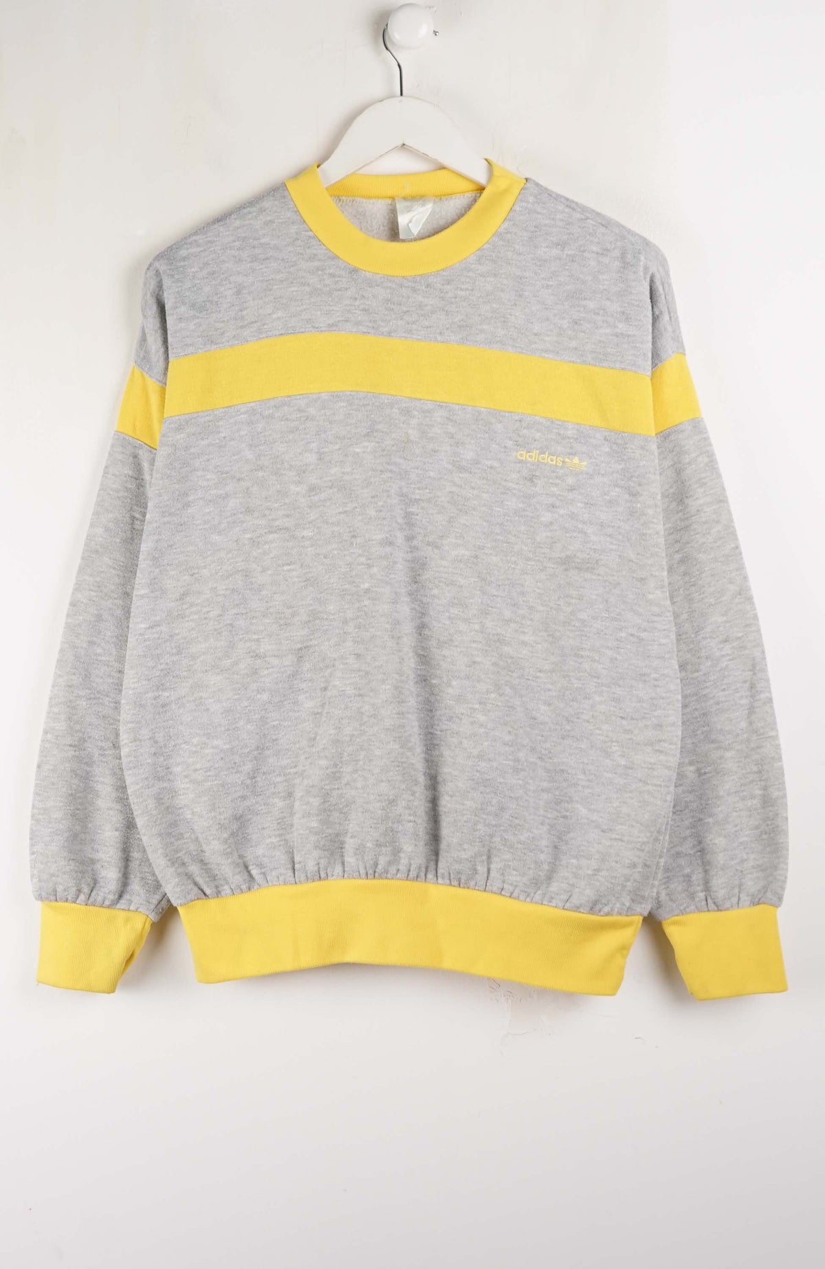 Gray sweatshirt with yellow accents on a white background