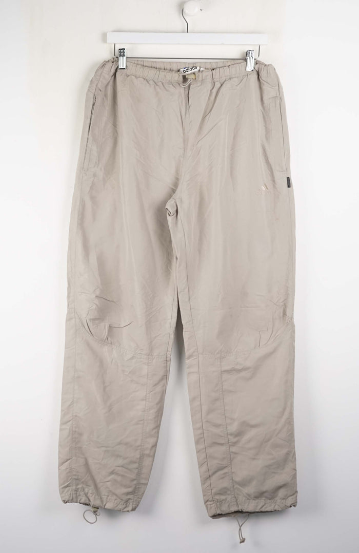 Beige pants hanging on a white wall