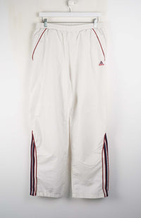 White pants with red and black stripes on a white background
