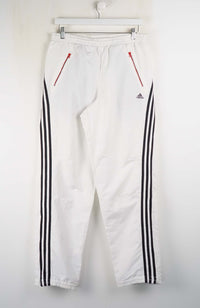 White pants with black stripes and red accents on a white background