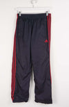 Black tracksuit pants with red stripes on a white background