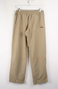 Beige pants with a brand logo on a white background