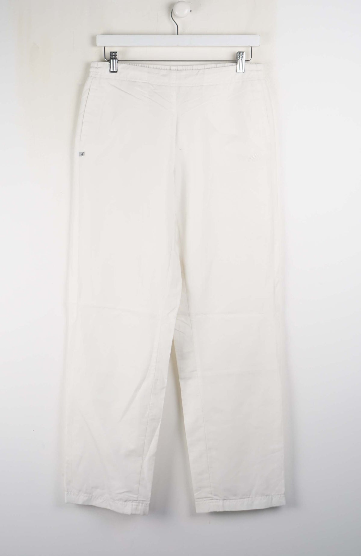 White pants hanging on a white background