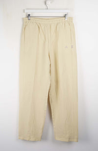 Beige pants hanging on a white background