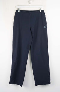 Navy blue pants with Adidas logo on a white background