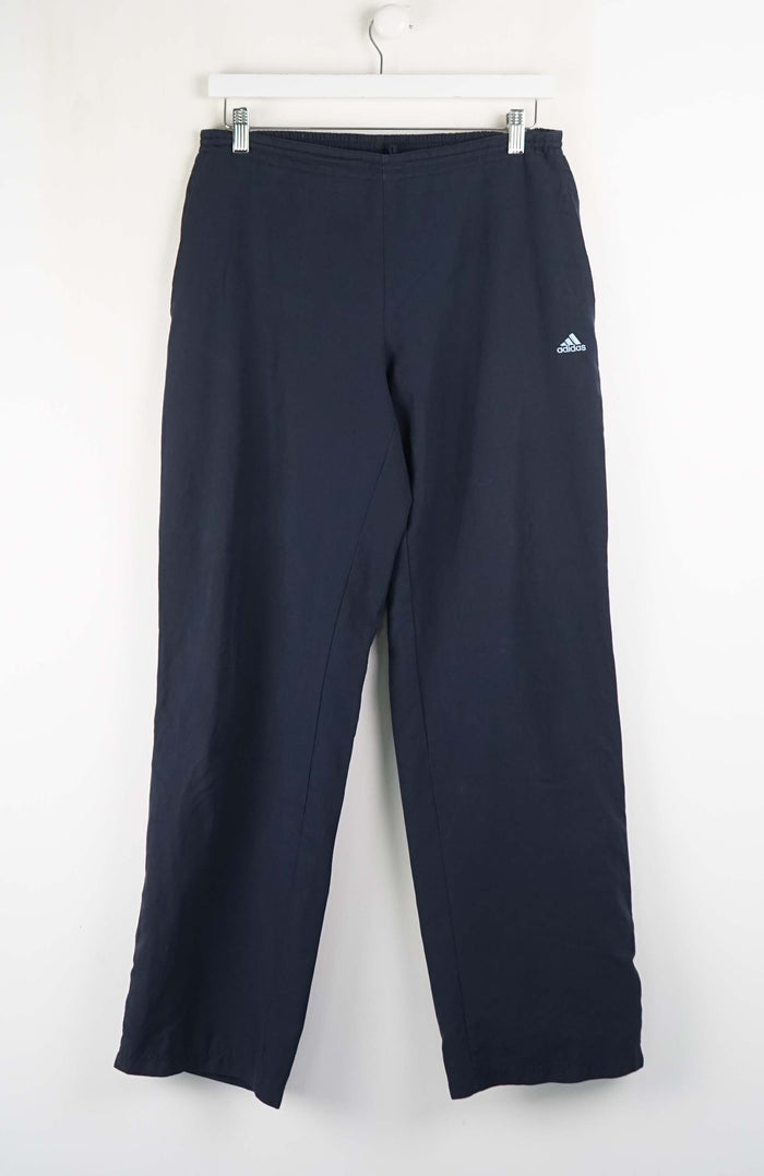 Navy blue pants with Adidas logo on a white background