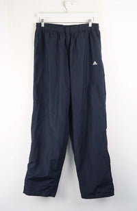 Navy blue pants with Adidas logo on a white background