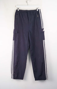 Navy blue pants with white stripes hanging on a white background